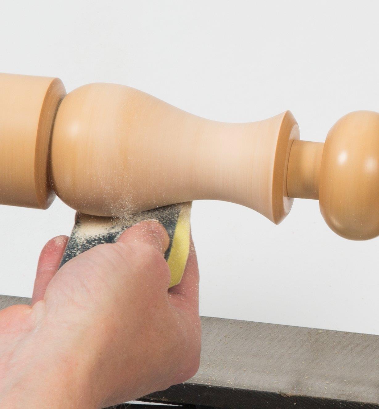 Sanding a spindle on the lathe