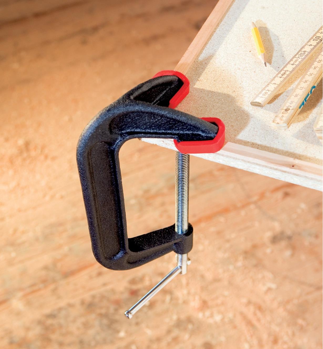 A Bessey double-jaw C-clamp used to clamp the mitered corner of a picture frame