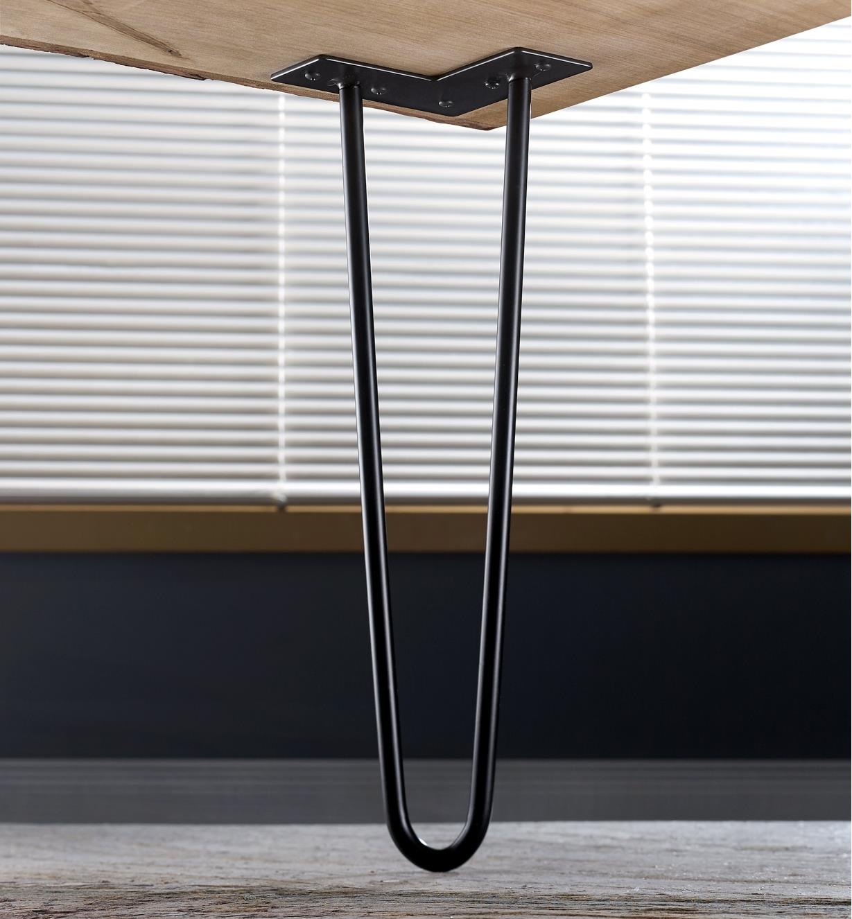 A 16-inch hairpin leg mounted on the corner of a live-edge coffee table