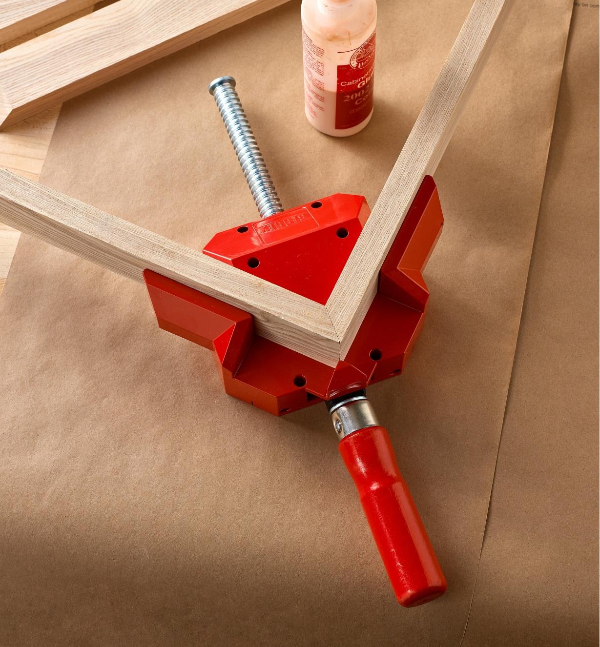 A Bessey corner and T clamp being used to hold a mitered corner for glue-up