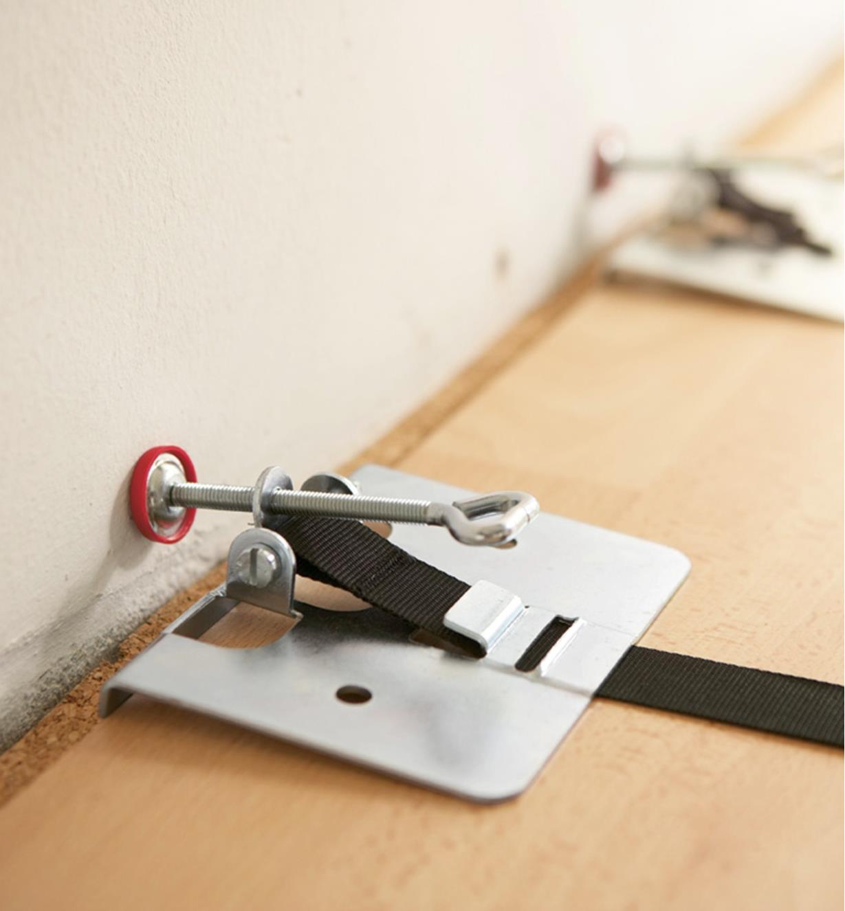 A Bessey flooring clamp strap used to offset rows of flooring from a wall during installation