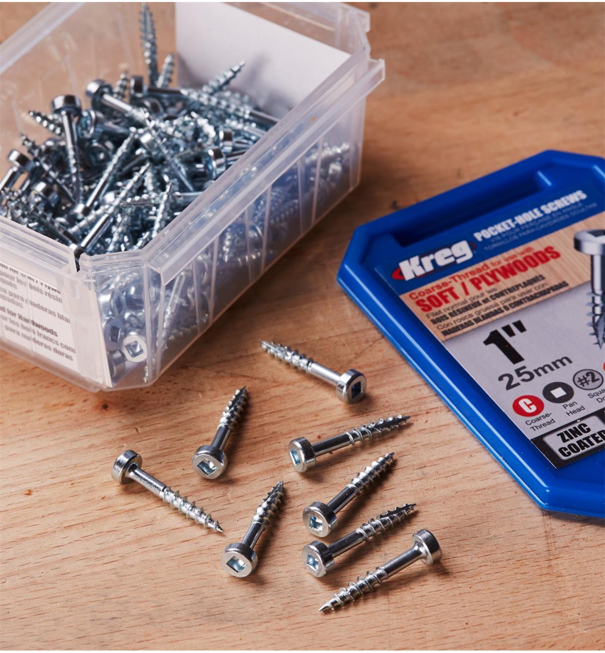 An open box of Kreg Pocket Screws with a few screws displayed on a wood surface