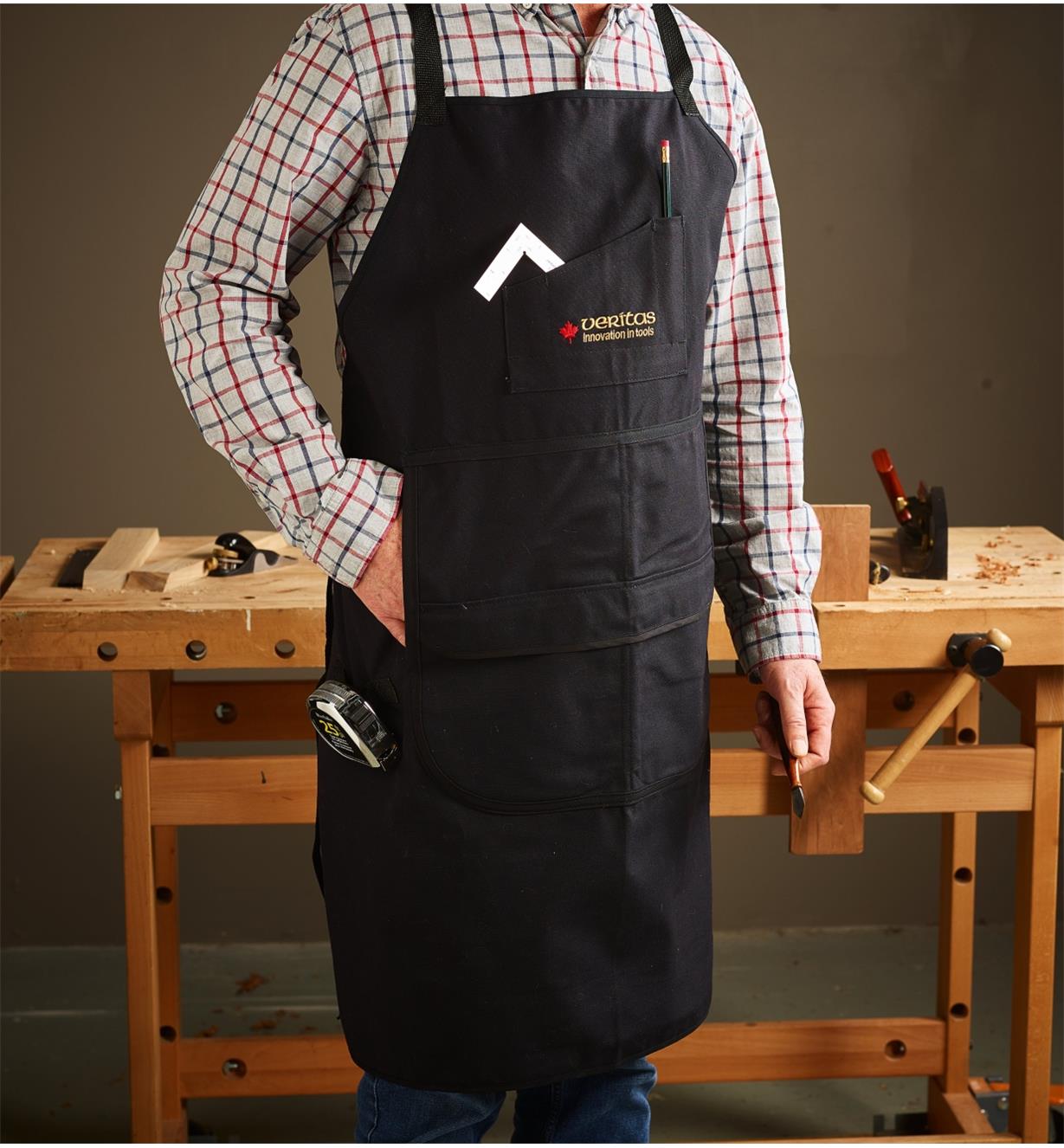 A man wearing a Veritas Apron in a workshop