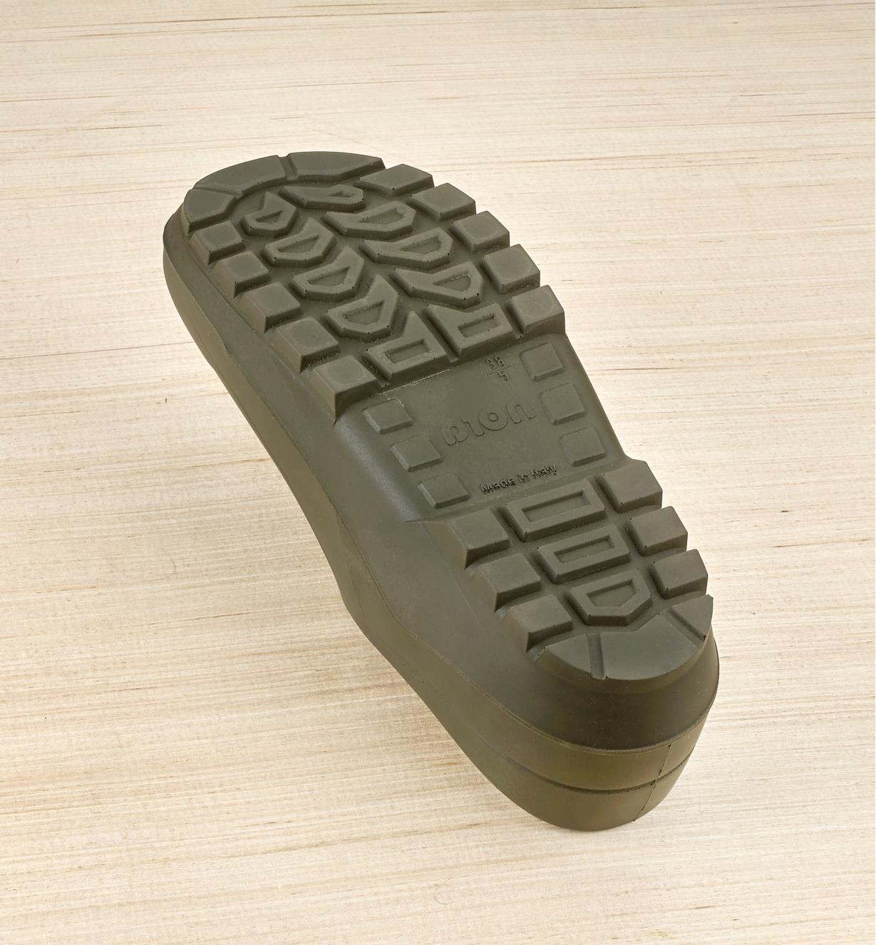 A bottom view of a European garden clog showing the widely spaced treads