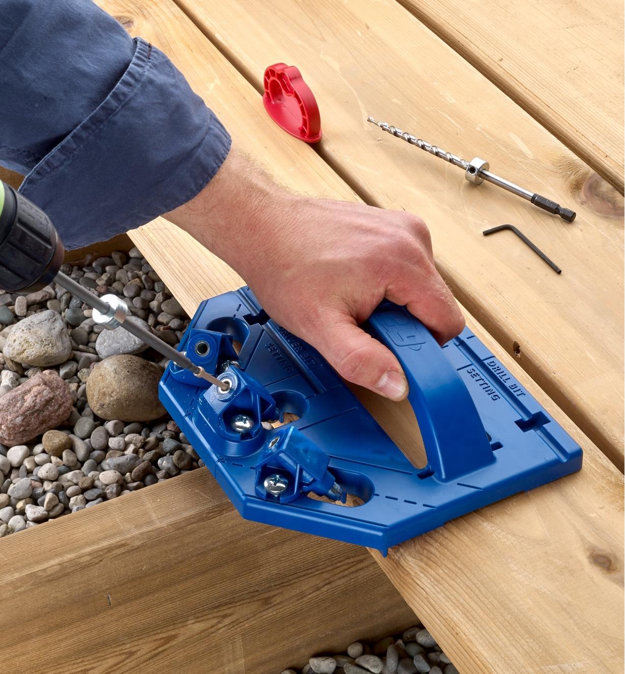Driving a screw into a deck board with the Kreg Deck Jig
