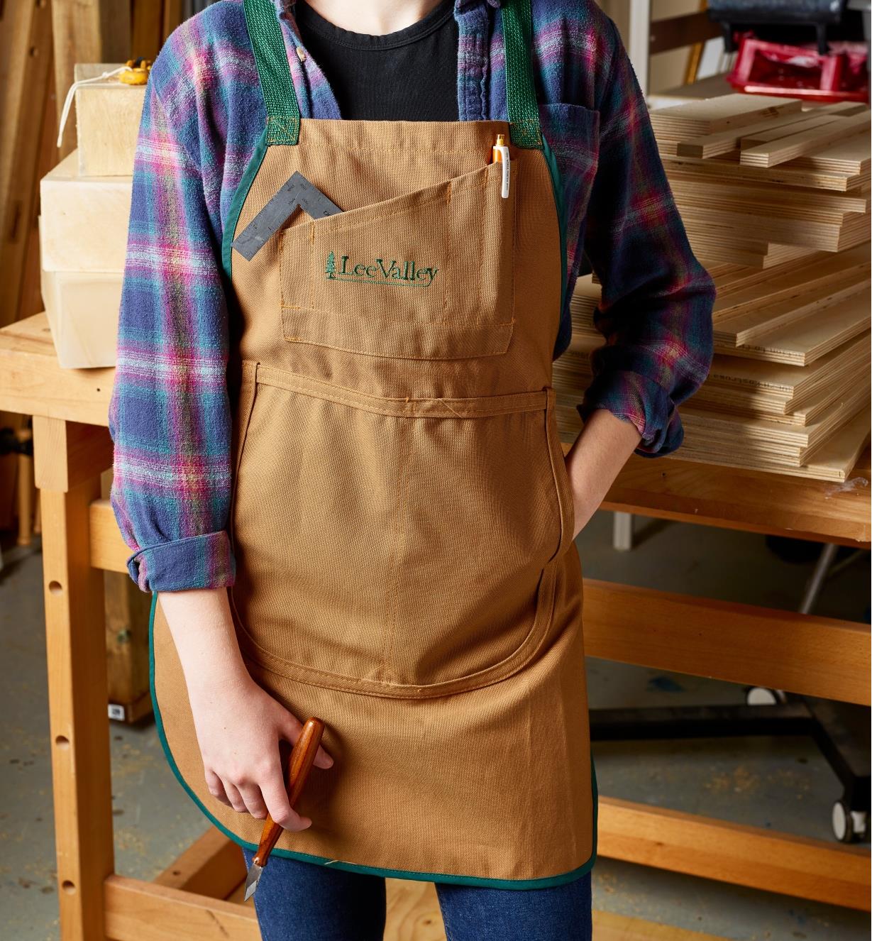 A person wearing a Lee Valley apron in a workshop