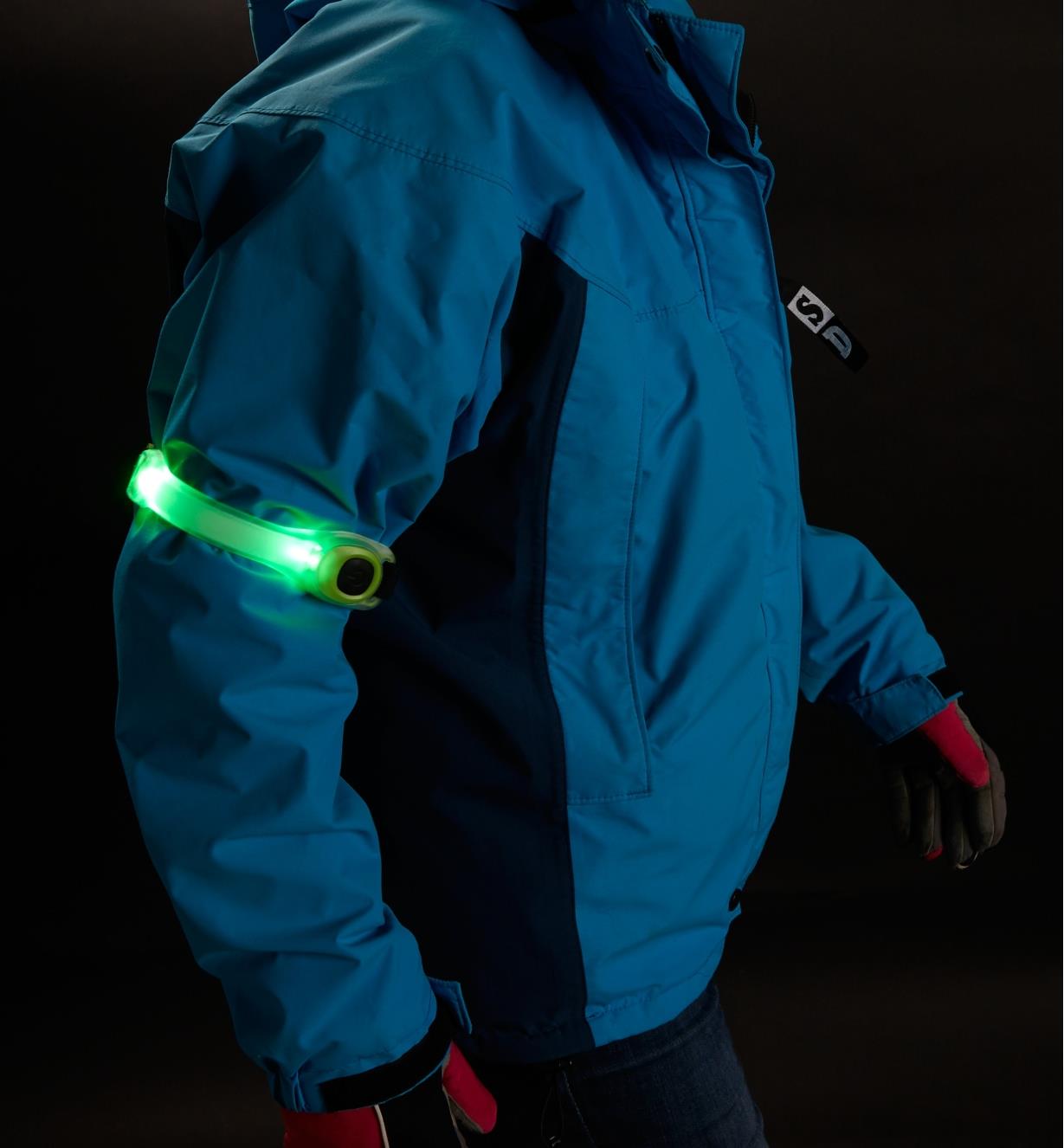 Green Wrap Light wrapped around the arm of a person's jacket at night