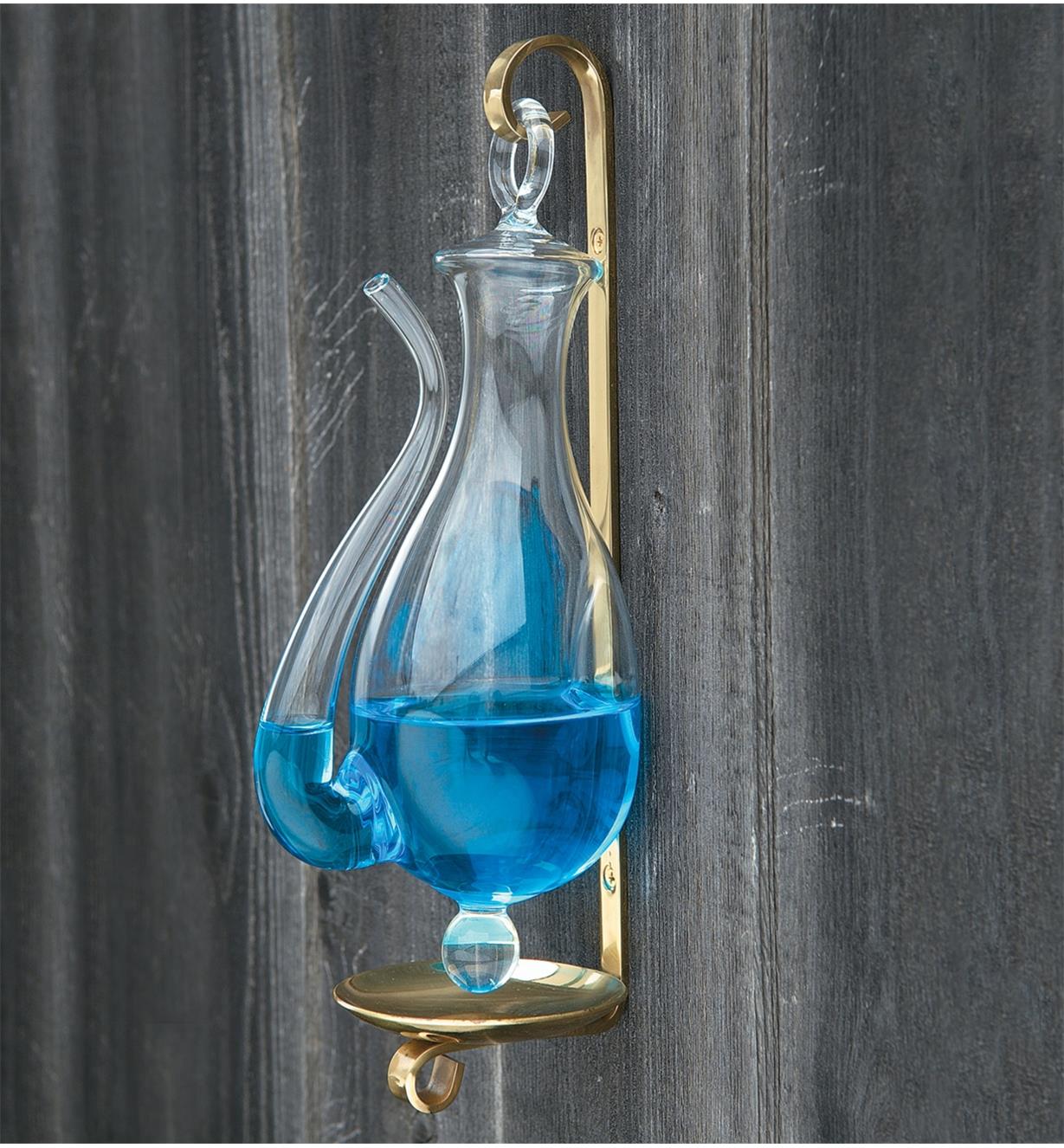 A filled Mariner Weather Glass hangs on a wall