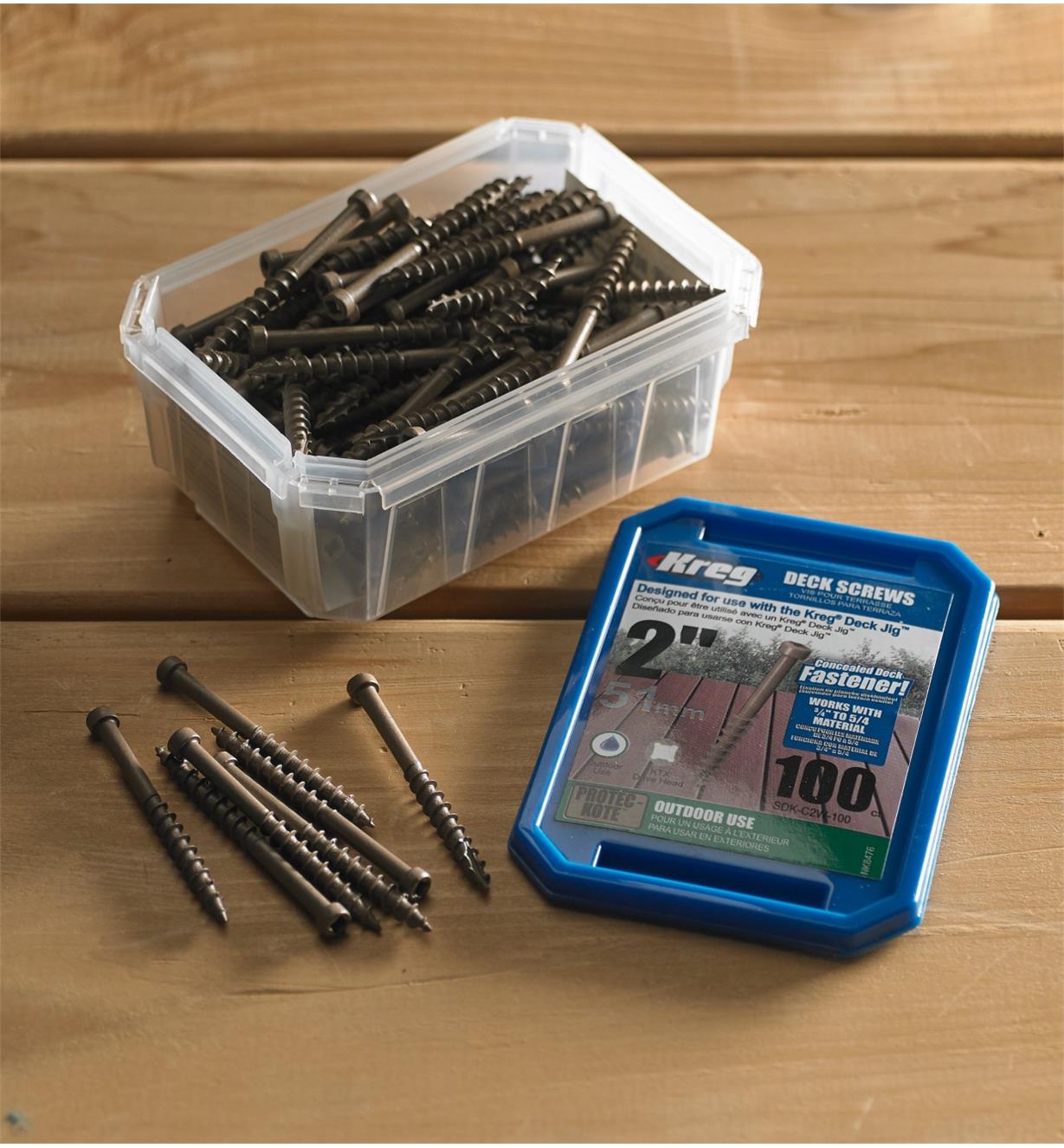 Open box of Kreg screws with several screws removed and displayed on a deck  