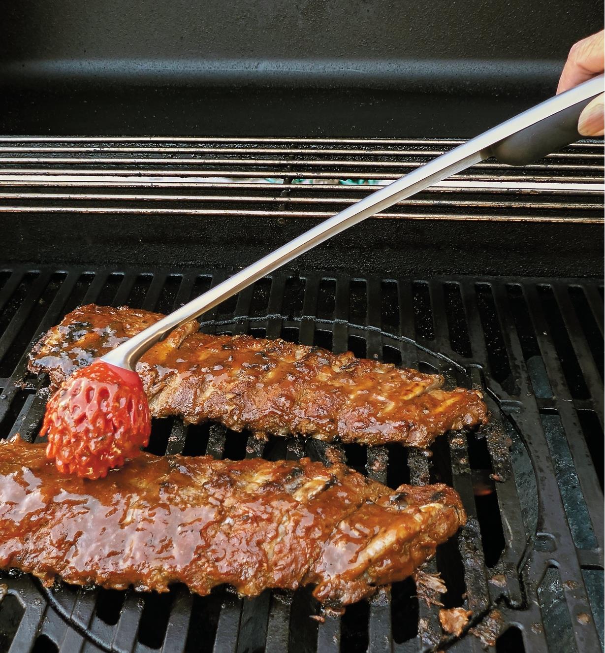 Using the Sauce Mop to baste steaks on the barbecue