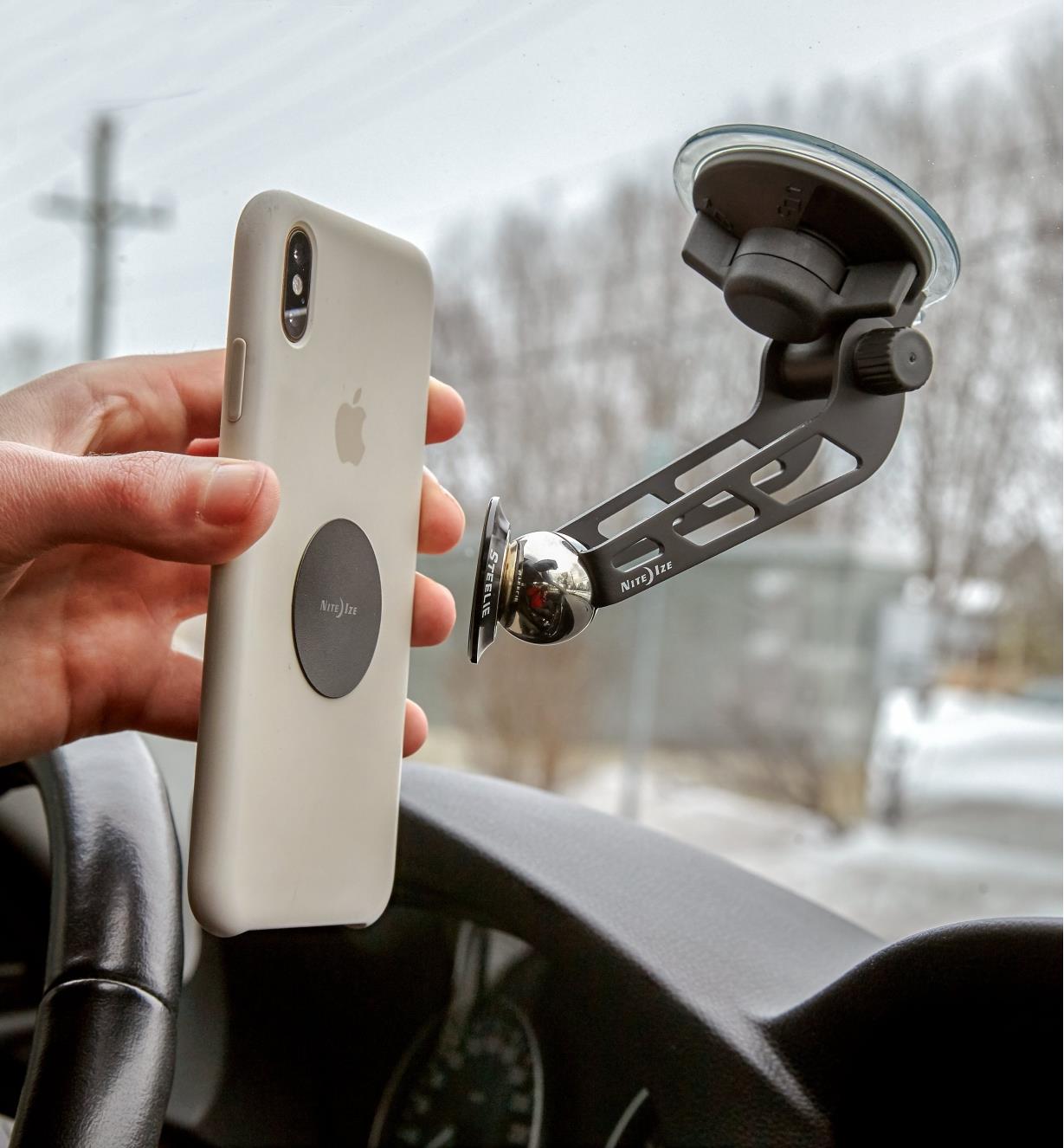 Attaching a cell phone to a Windshield-Mount Kit installed on a car windshield