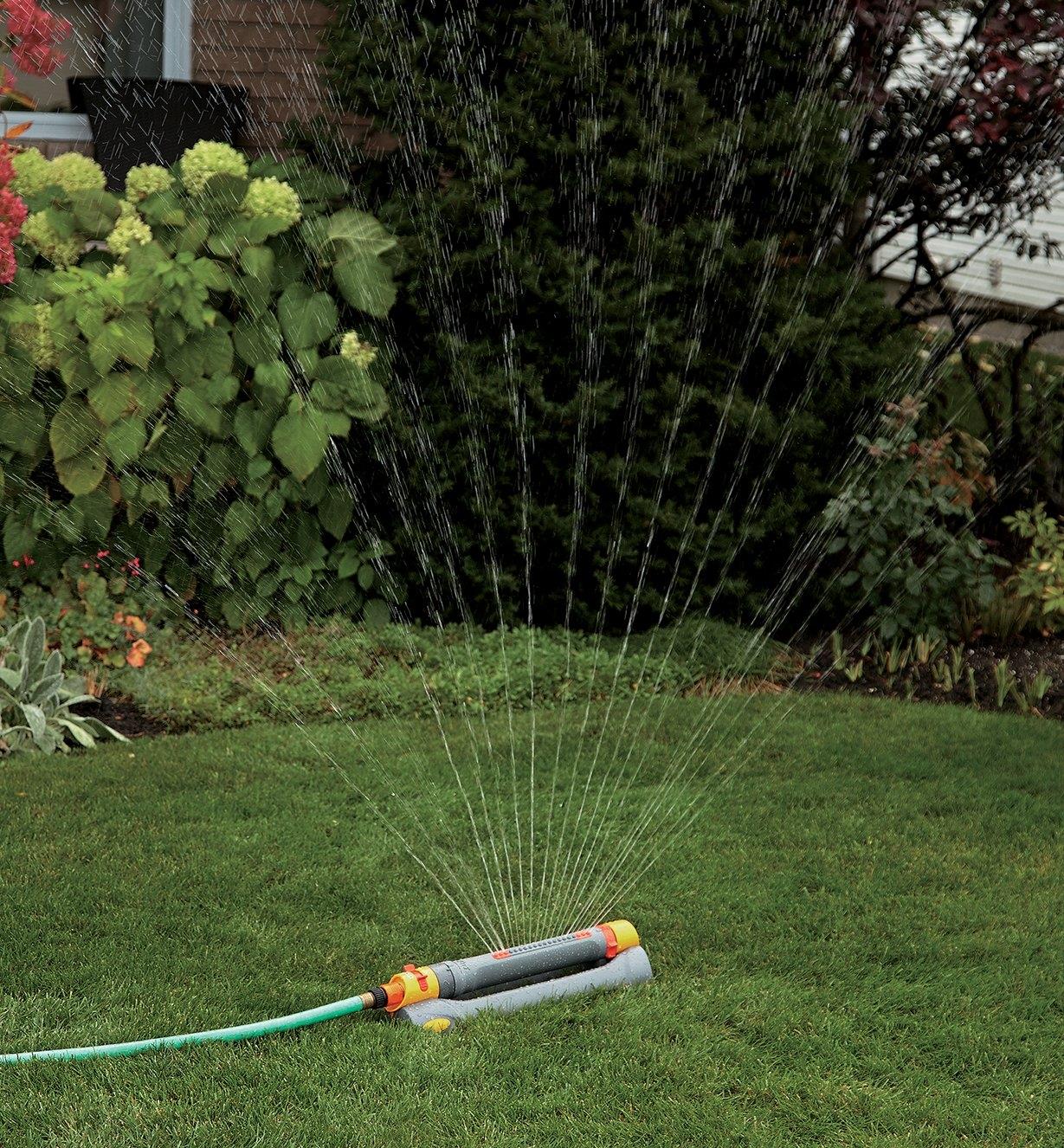 Hozelock Multi-Adjust Sprinkler/Mister watering a lawn with full spray setting
