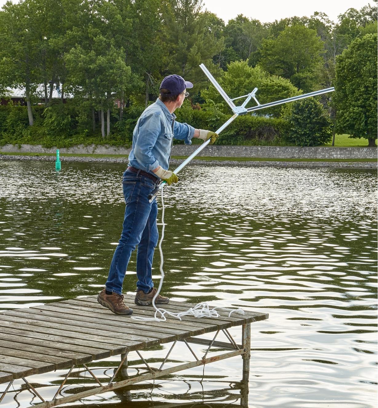 A man at the end of a dock holding a Weed Razer Pro