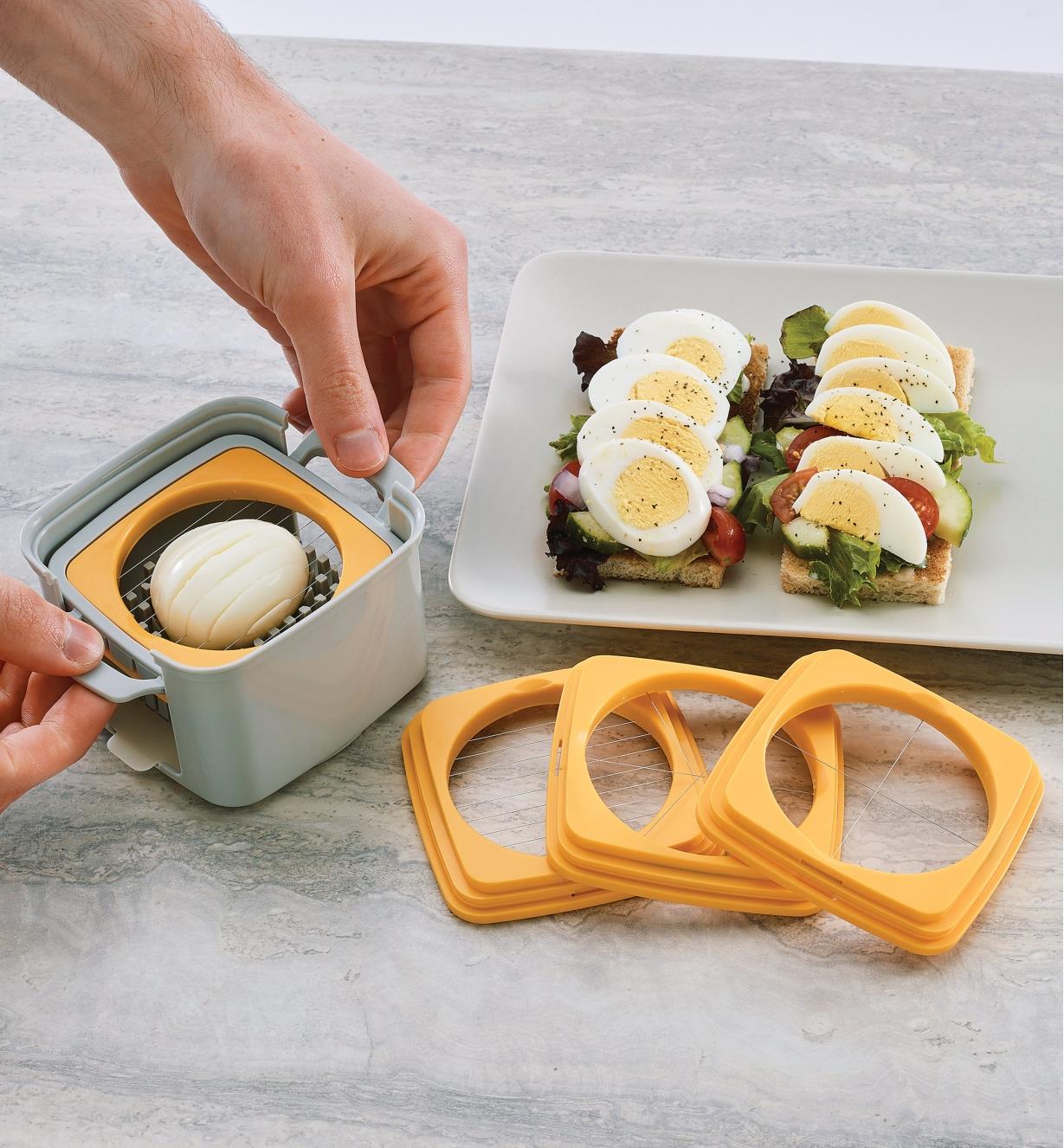 Slicing an egg with the Egg Cutter, with a appetizer made with sliced eggs nearby