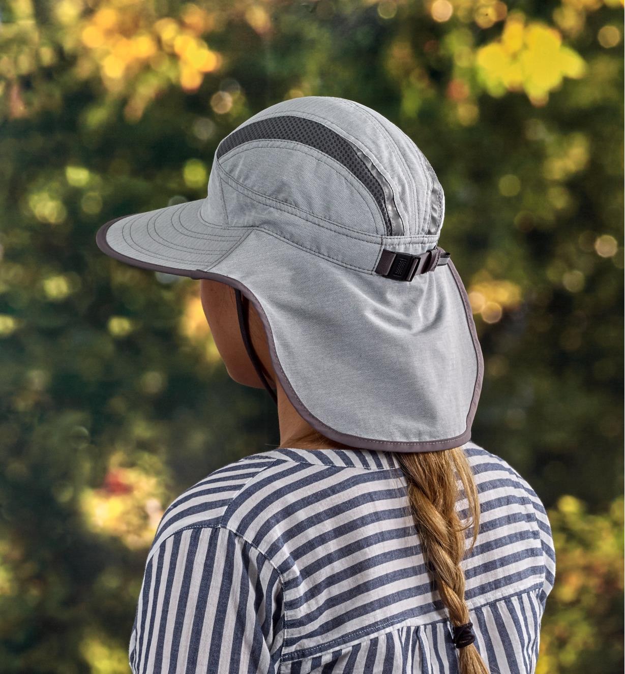 Back view of a woman wearing a light gray adventure sun hat