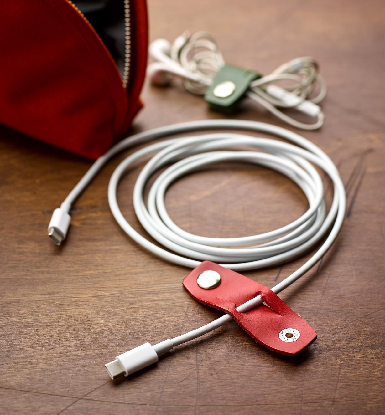 Electronics cord with an open Leather Cord Keeper attached to it