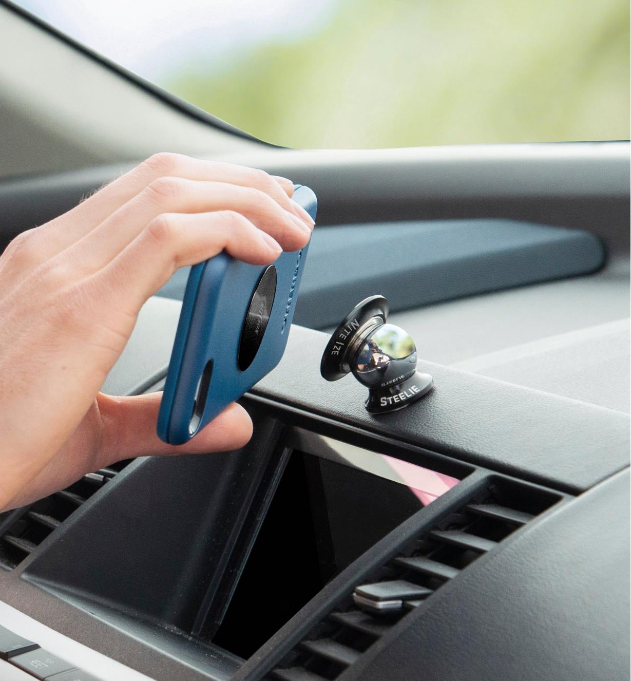Attaching a cell phone to a dashboard-mount kit installed on a car dashboard 