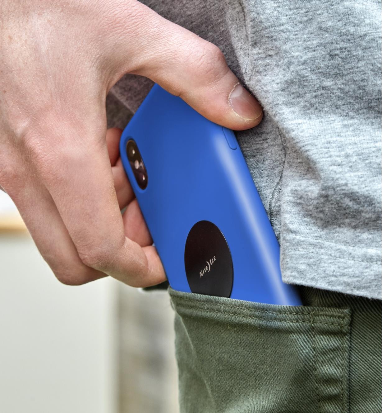 Slipping a cell phone with a steel disc attached to its case into a pants pocket