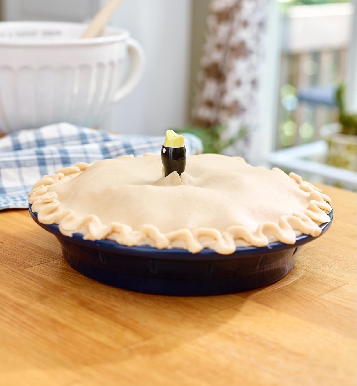 Unbaked pie with the head of the Pie Bird in the center