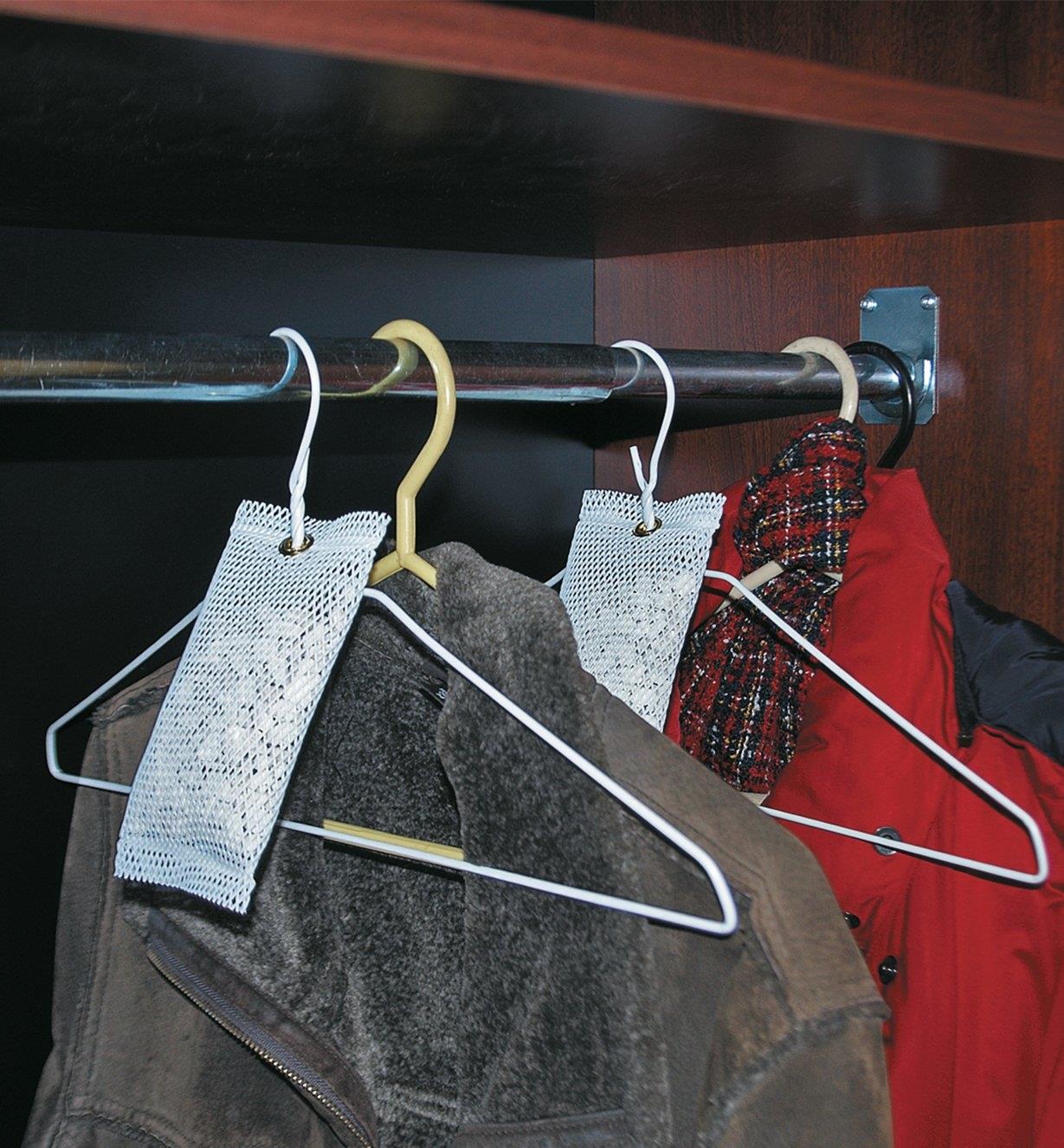 4 oz Deodorizers hanging from clothes hangers in a coat closet