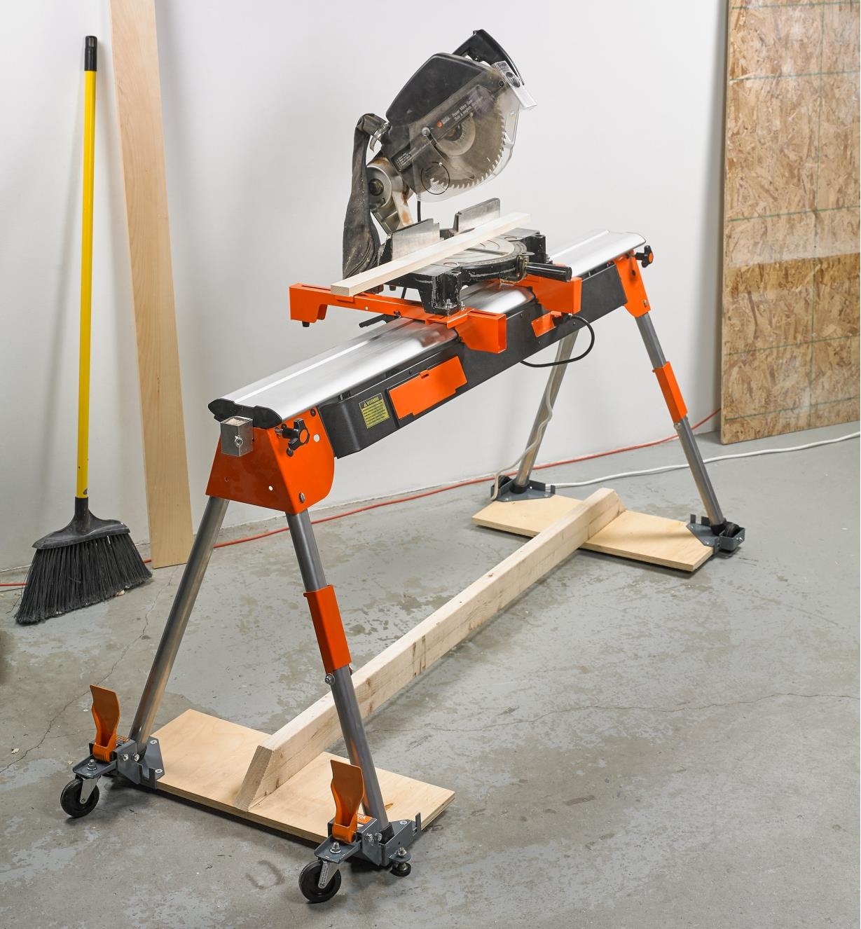 Mobile base supporting a sawhorse holding a chop saw