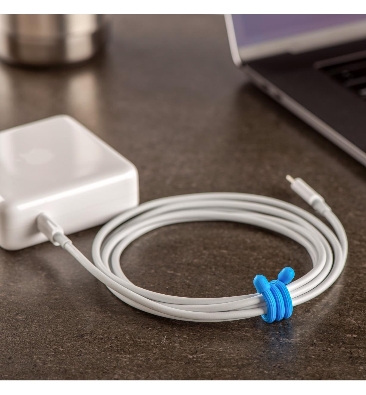 6” blue gear tie used to bundle a laptop charging cord