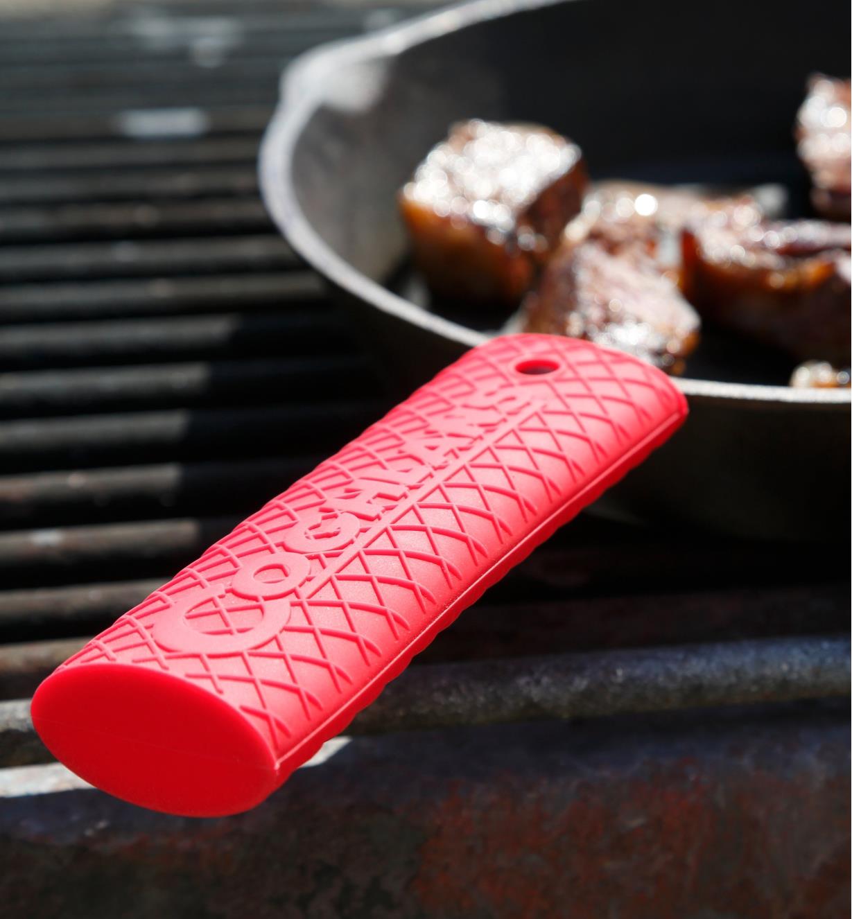 Silicone cast-iron handle grip used when cooking on an outdoor barbecue grill