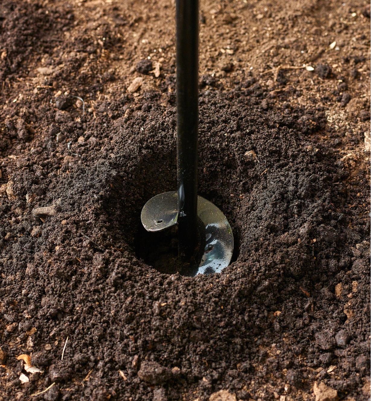 Close-up of garden auger drilling into soil