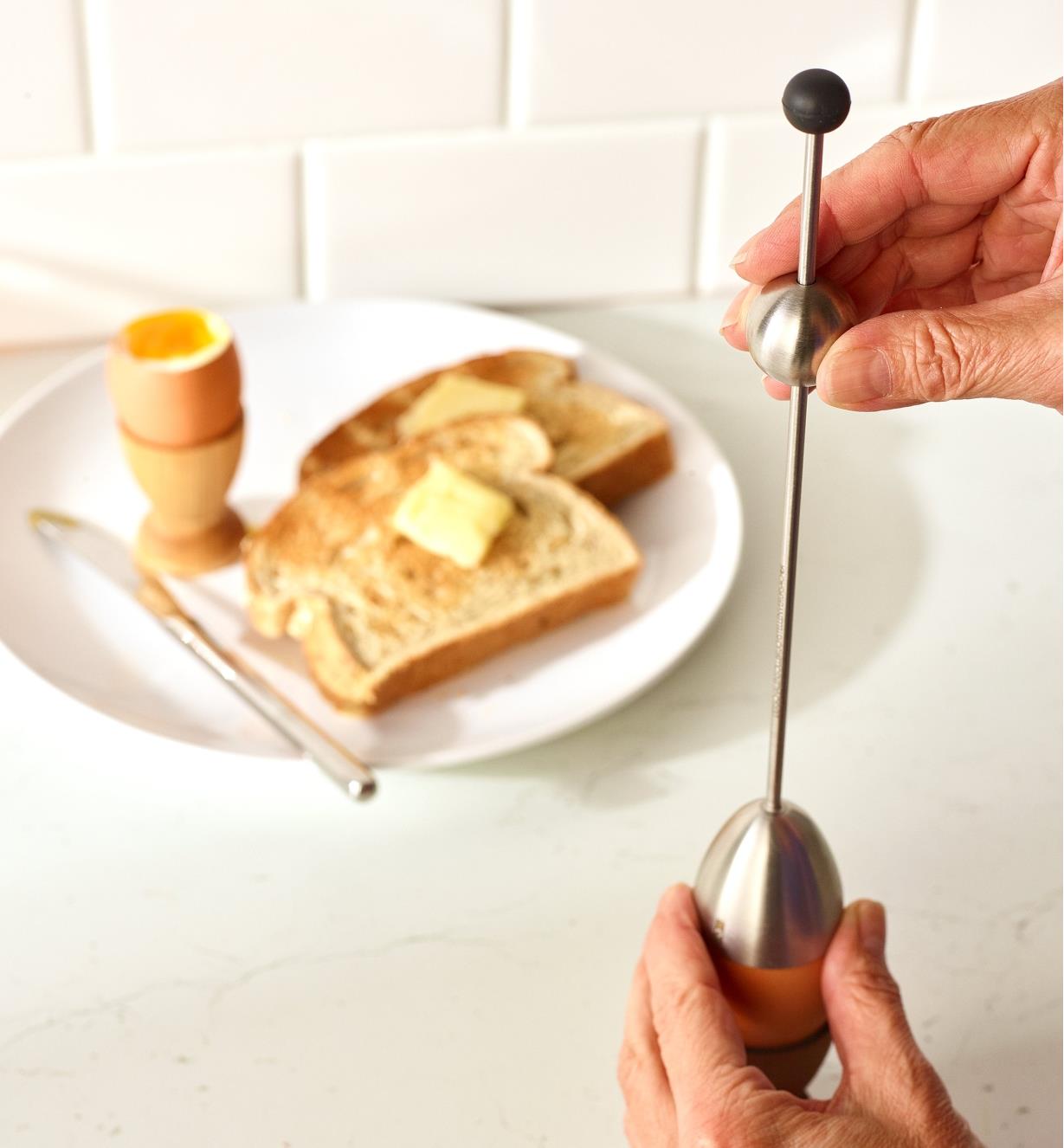 Lifting the weight of the Clack Soft-Boiled Egg Topper above an egg