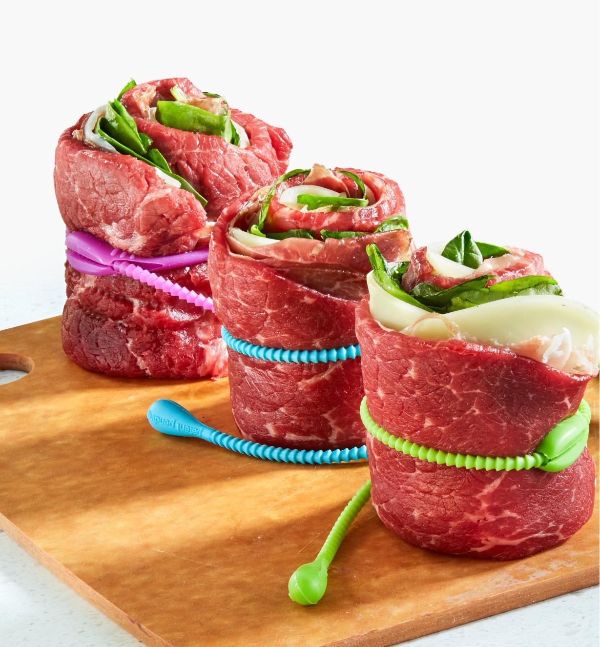 Three stuffed beef roulades secured with FoodLoop, ready for cooking
