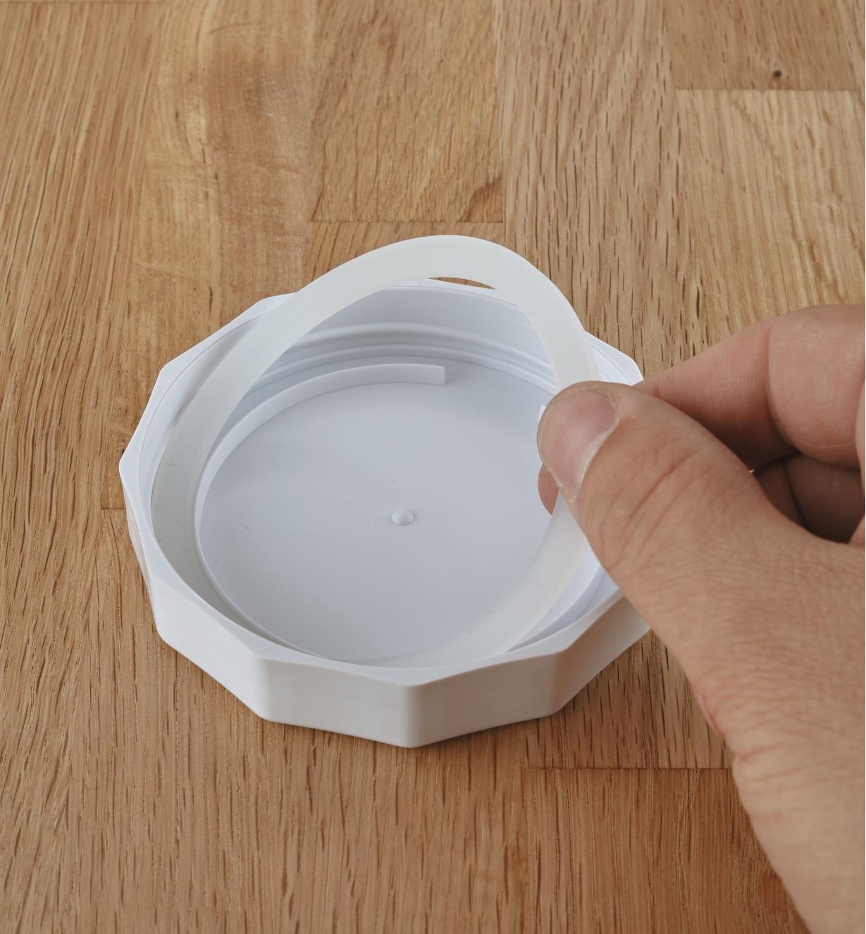 Removing the gasket from a canning jar lid