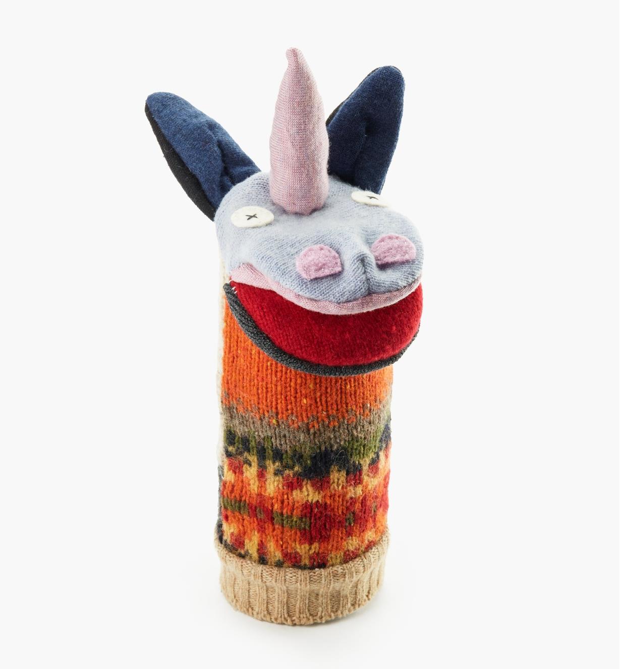 A completed unicorn puppet fitted over its canister, which is used as a display stand