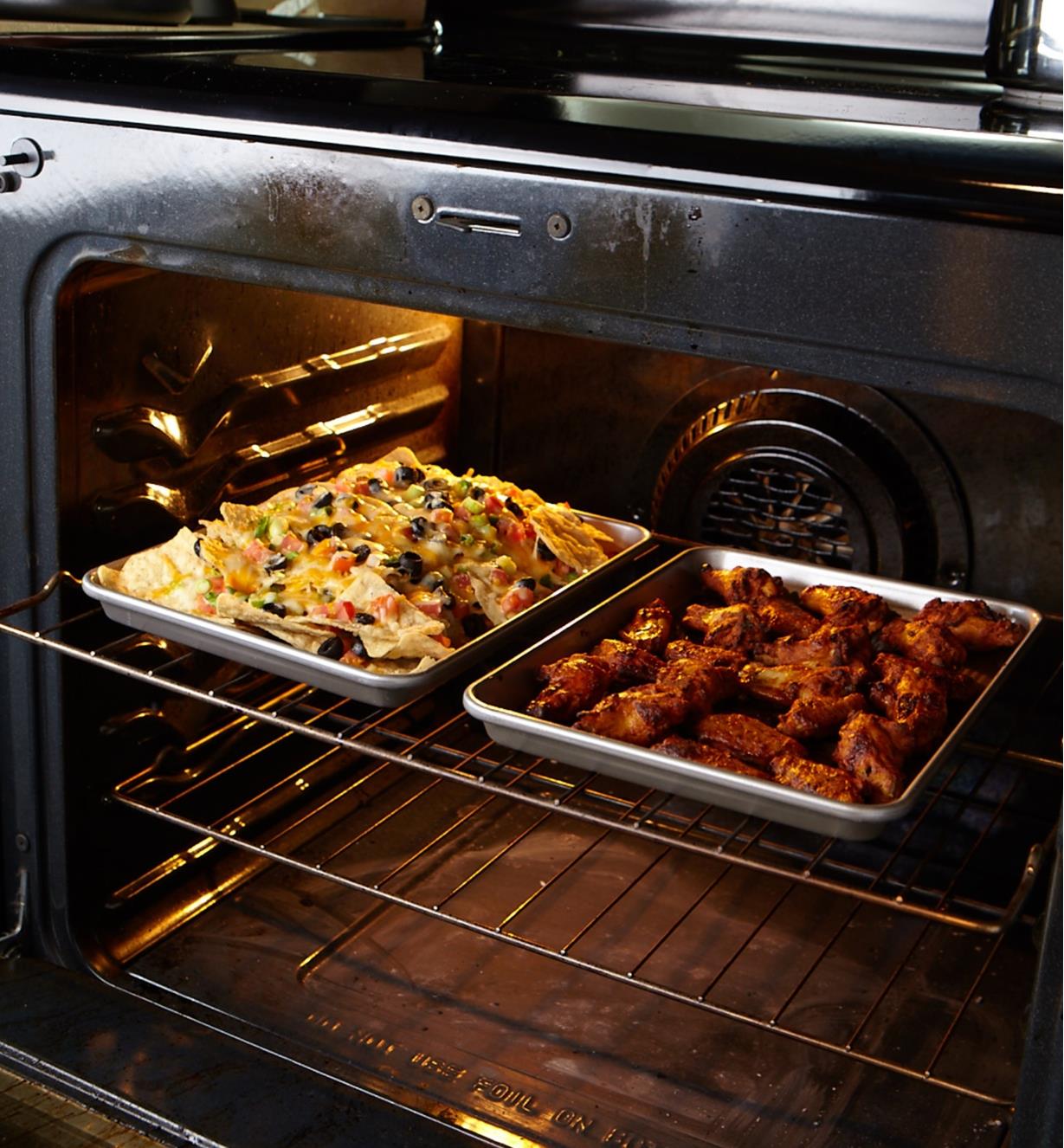 Two quarter sheet baking pans side by side on rack in oven.