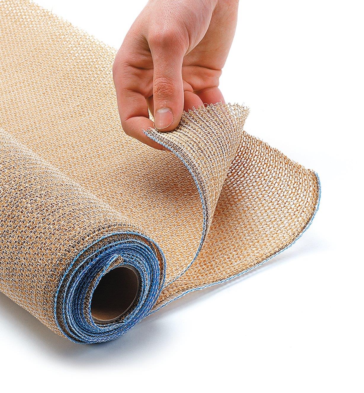 One end of the shade fabric roll is turned back to show the knitted fabric and stitched edges