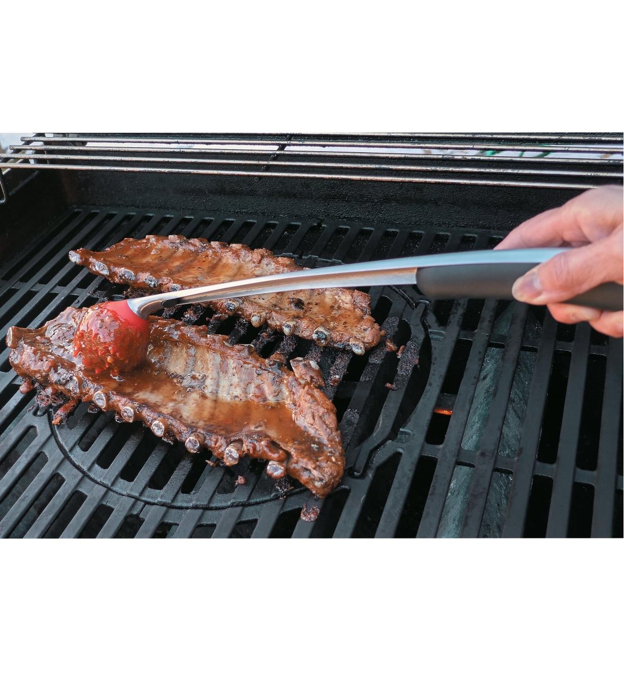 Using the Sauce Mop to baste steaks on the barbecue
