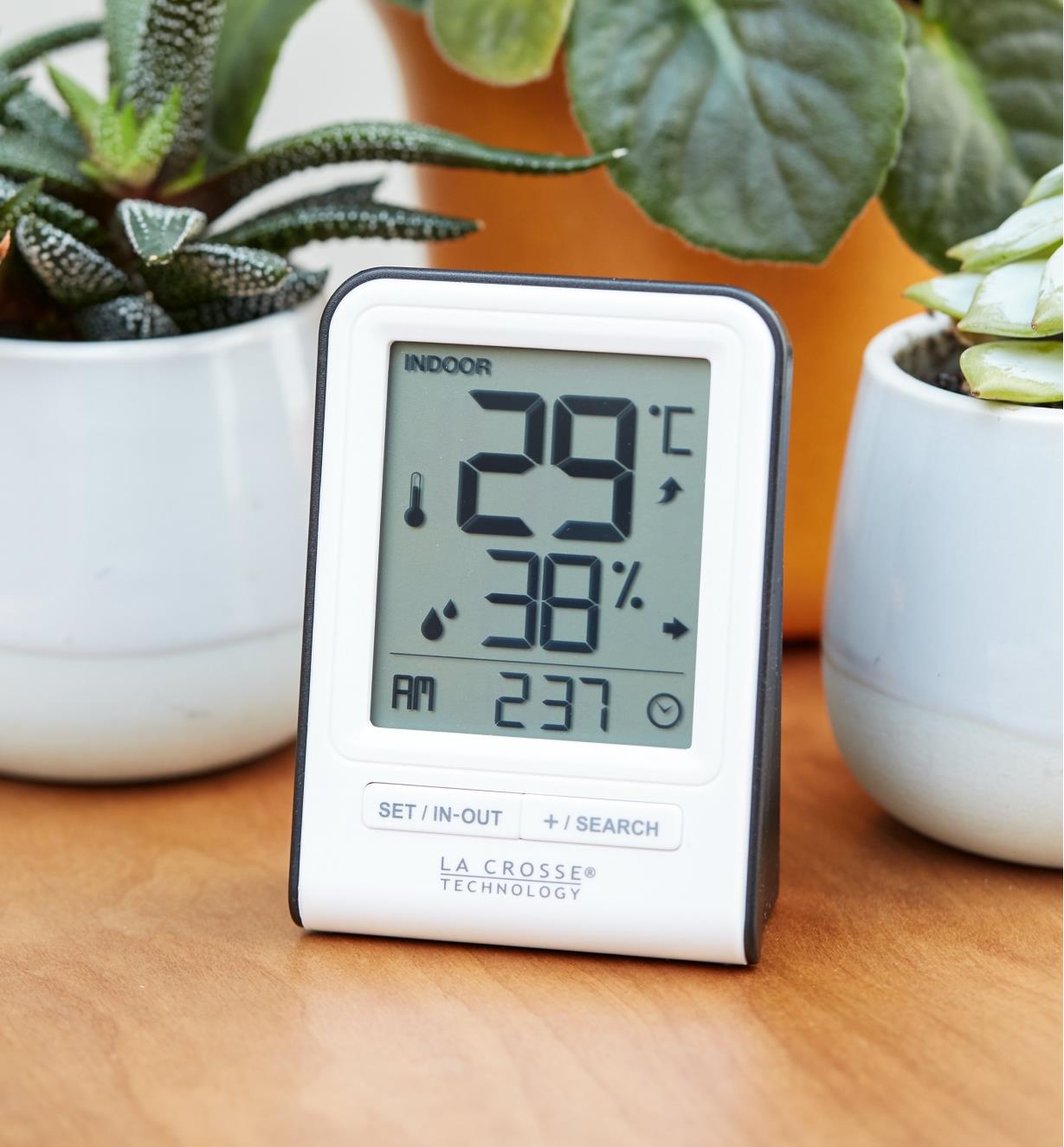 The small secondary display of the Wi-Fi weather station with wind and rain sits on a tabletop
