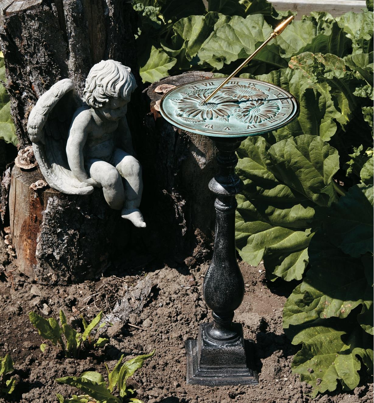 Flowers sundial and pedestal in a garden