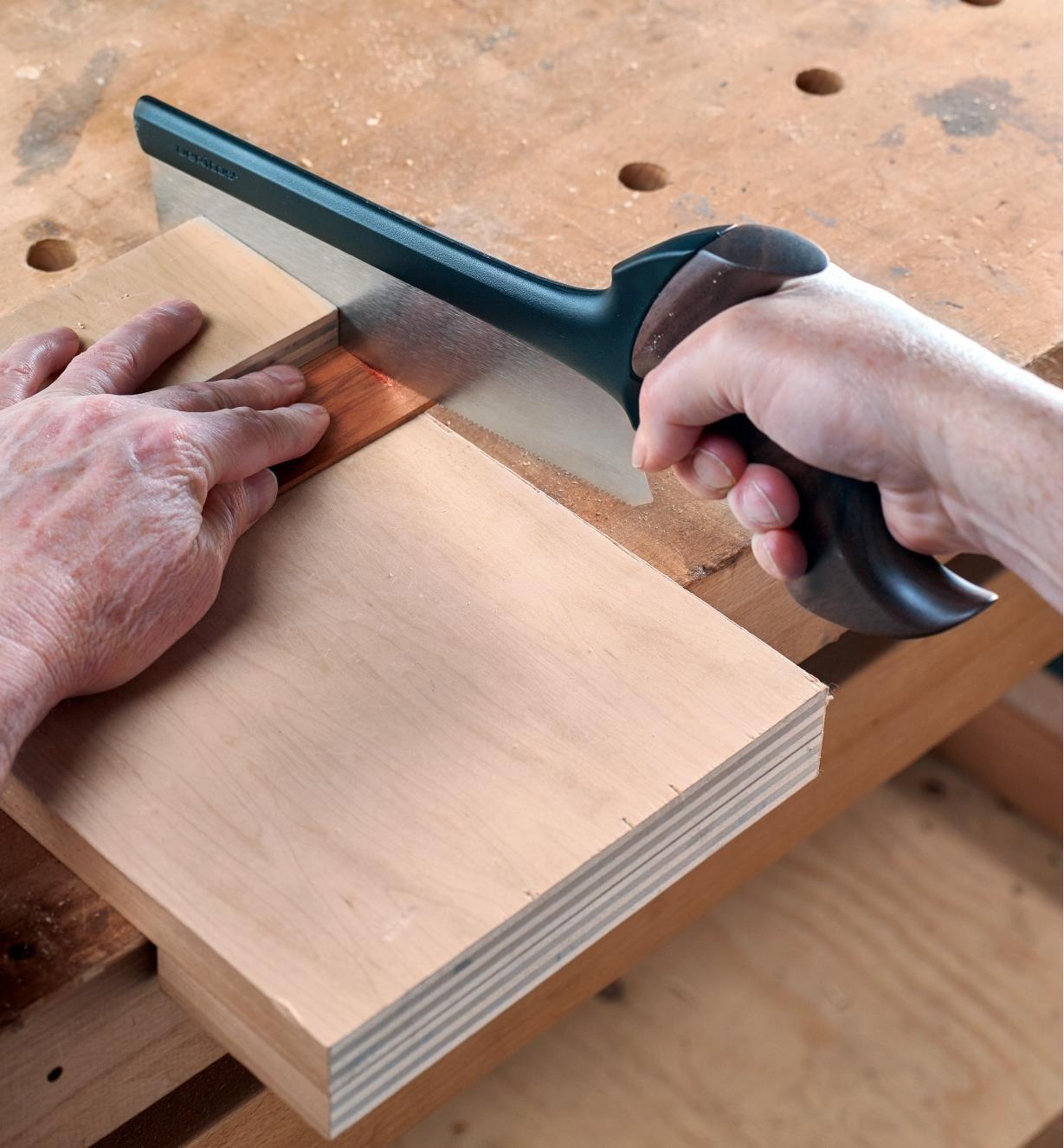 Using the Veritas Small Fine-Tooth Crosscut Saw to cut a thin piece of wood across the grain on a bench hook