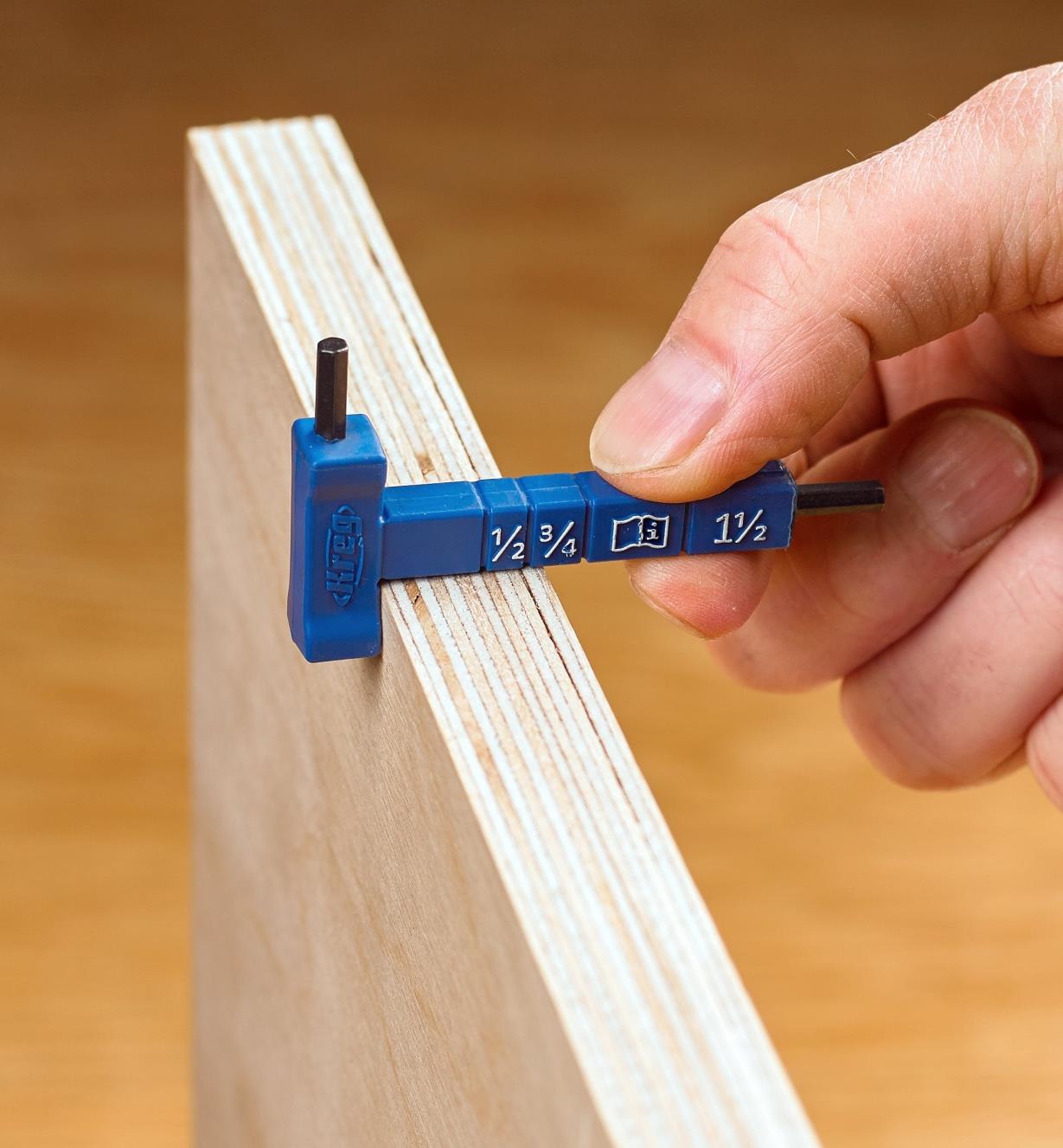 The Kreg material-thickness gauge being used to check the thickness of a plywood panel