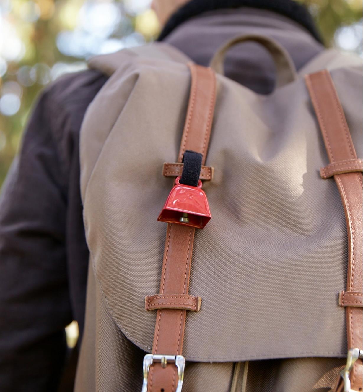 Bear bell attached to a backpack by its Velcro strap