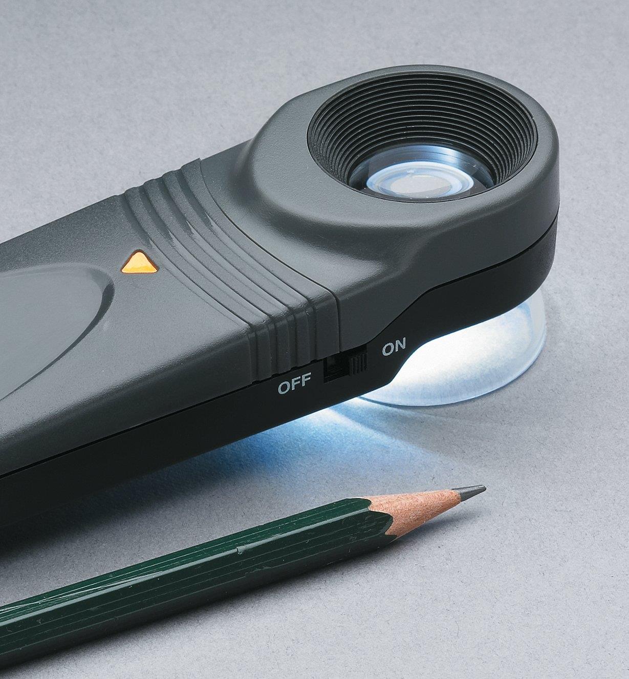 15-Power Lighted Loupe next to a pencil