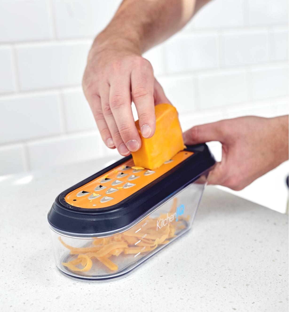 Shredding cheese with the container grater
