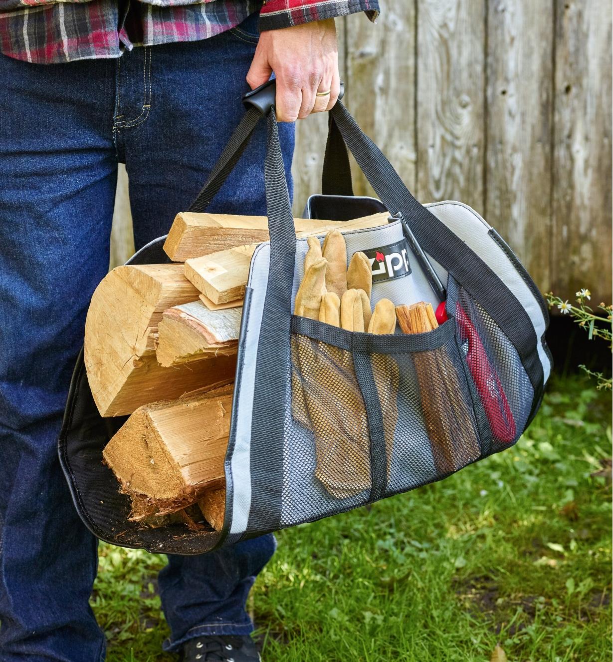 Carrying firewood in the campfire carrier, with work gloves, fire starters and a lighter in the side pocket