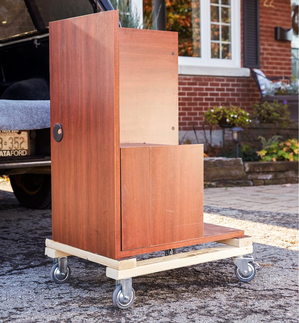 Furniture sits on a homemade dolly that has heavy-duty casters