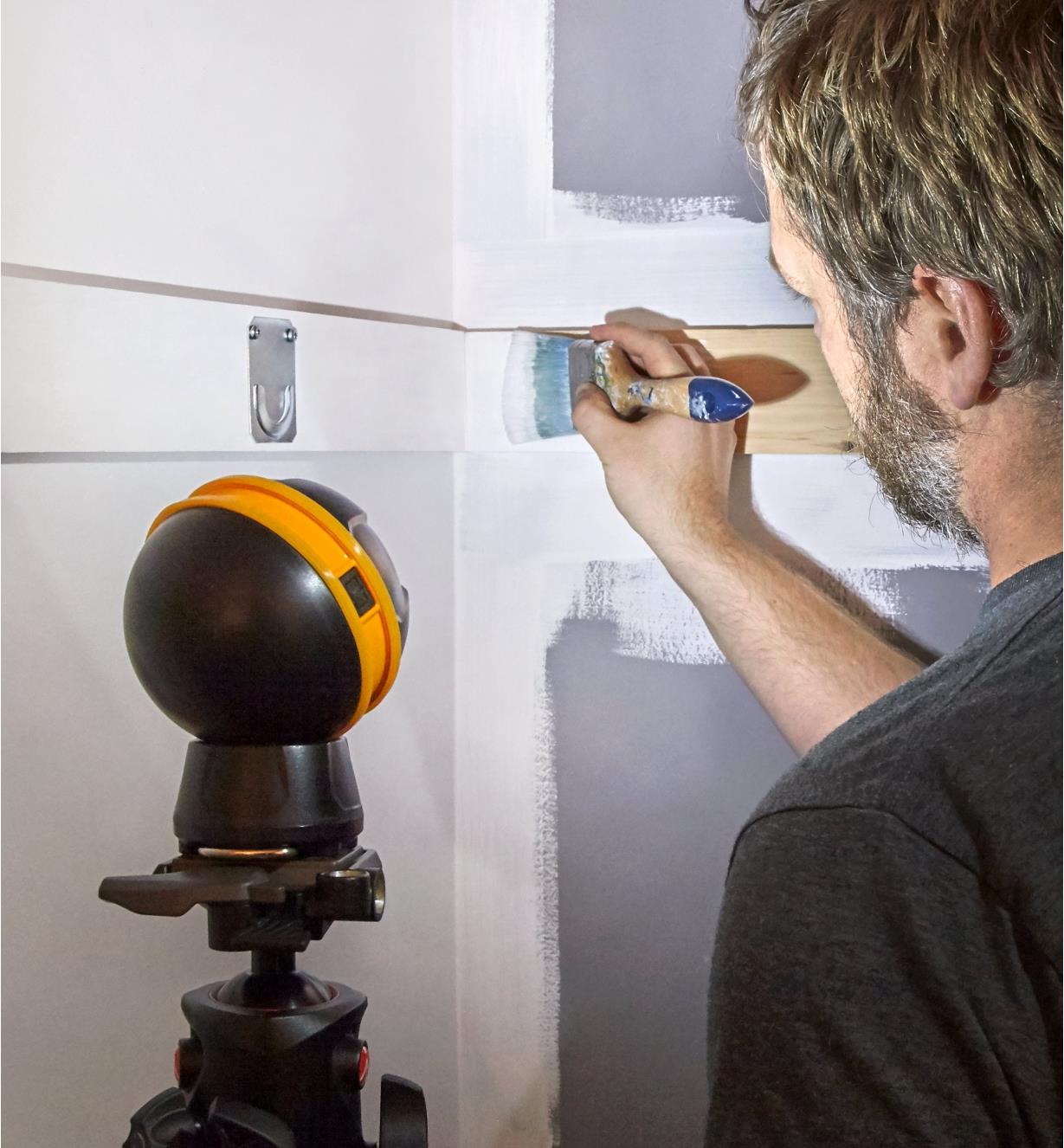 A rechargeable orb light mounted on a tripod to illuminate inside a closet that is being painted