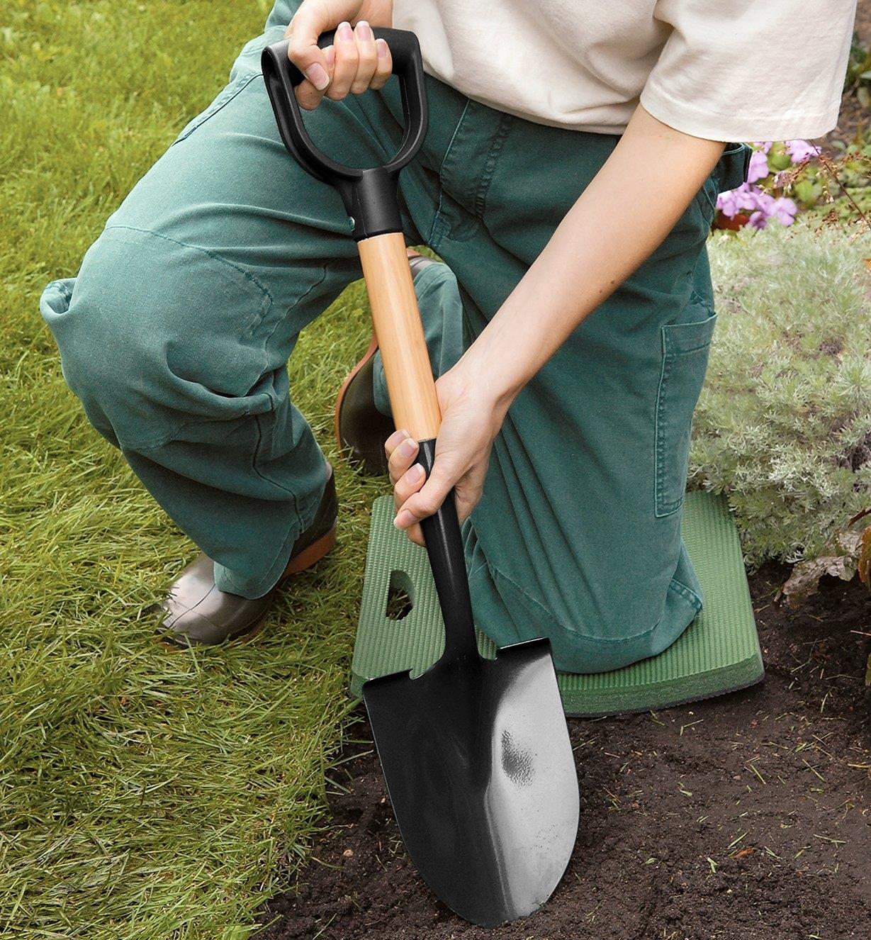 Using the Mini Shovel to dig in a planting bed
