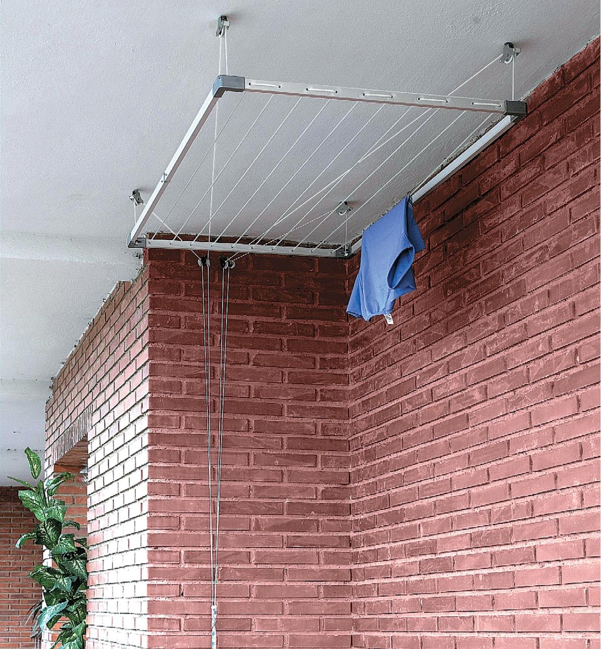 Drying rack in raised position close to a ceiling