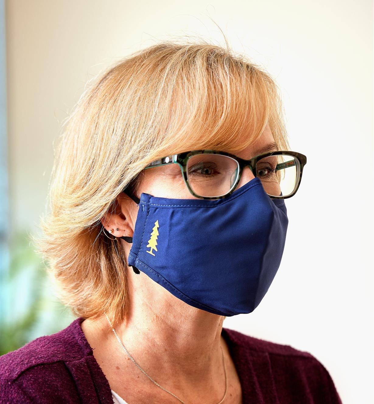 A close view of a woman wearing a Lee Valley face mask and eyeglasses
