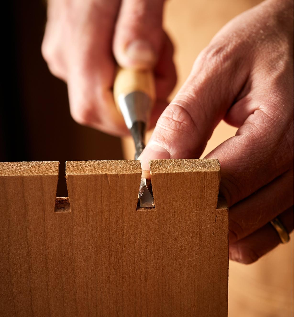 Using a Japanese dovetail chisel to clean out the bottom of a pin socket on a dovetail joint