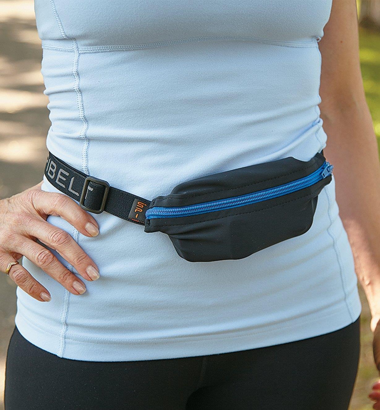 A woman wearing a black and blue pocket belt